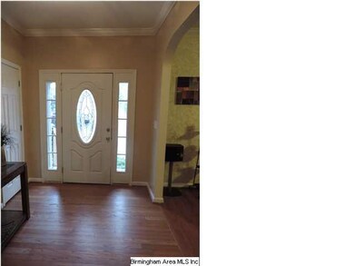 ENTRANCE FOYER WITH HARDWOOD FLOORS.