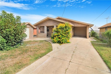 Back side of property with a one car cartport