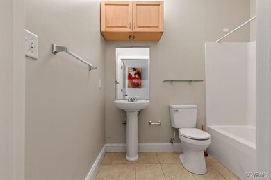 Full bath featuring toilet, tile patterned floors,