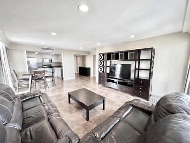 Living room, view toward kitchen and entry