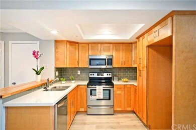 Brand new kitchen with wood like tile flooring and