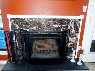 Family Room. The beautiful marble log burning fire