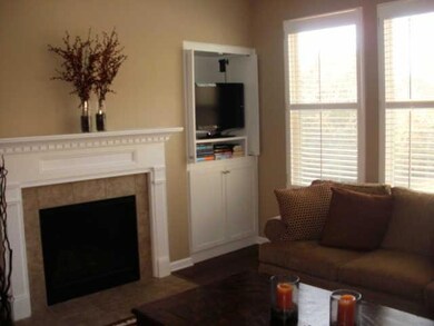 The LR features a gas FP, window wall, gleaming hardwood floors and built ins.