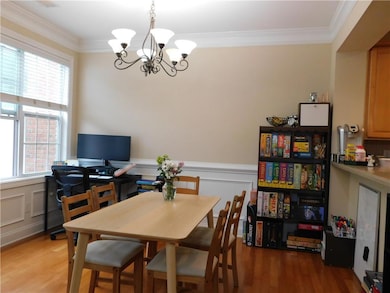 Dining space featuring a chandelier, light wood fi