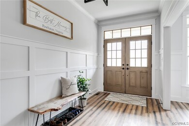 Charm central! Double wood front doors, transom for adding in even more natural light, and the moulding and trim work is simply timeless.