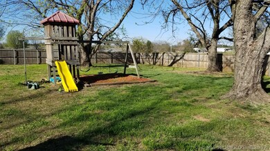 Large back yard with a kids play set. Privacy fenc