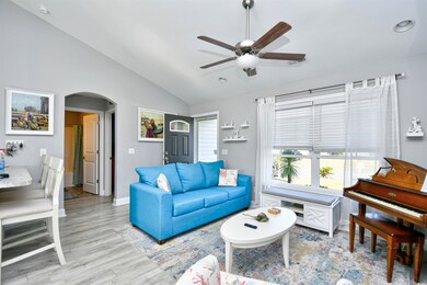 Living room with lofted ceiling, light hardwood / 