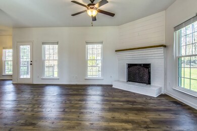 Living Room with gas burning fireplace. Lots of natural light from the large windows. 