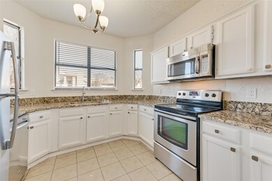 Kitchen featuring sink, a textured ceiling, stainl