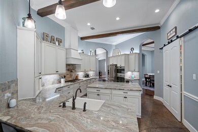 This open layout features a chef’s island kitchen