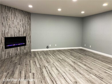 Unfurnished living room with recessed lighting, ba