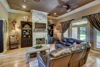 The living room features the rustic stone fireplace with the perfect blend of elegance.