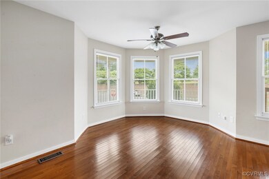 Empty room featuring ceiling fan and hardwood / wood-style flooring