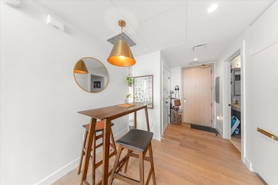 Dining space with electric panel, light wood fini