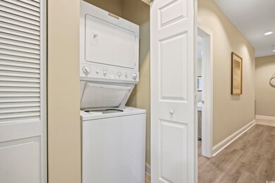 Washroom with stacked washer and clothes dryer and