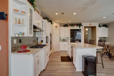 New kitchen counter tops, glass backsplash, flooring and tons of white cabinets/storage and pantry,