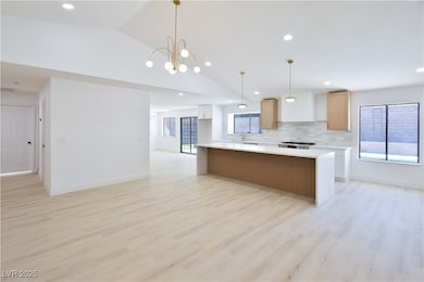Kitchen featuring tasteful backsplash, light count