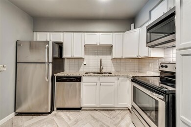 Kitchen featuring sink, light parquet floors, whit