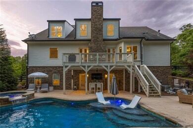 Back of property at dusk with a patio, a chimney, 