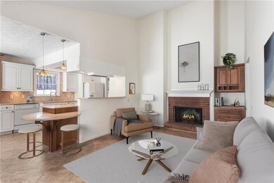 Open family/den with vaulted ceiling, brick firepl