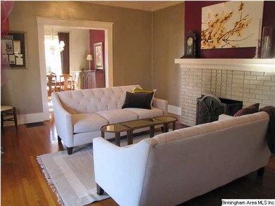 Spacious living room with high ceilings, hardwood 