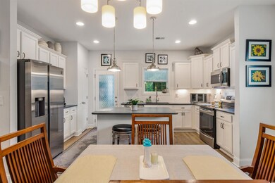 Kitchen featuring white cabinetry, stainless steel