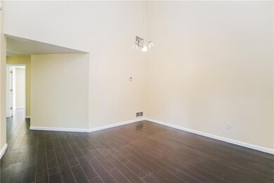 Unfurnished room featuring dark wood-type flooring and baseboards