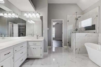 Bathroom with a shower stall, double vanity, a fre