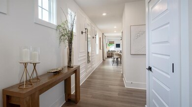 Corridor featuring dark wood-style flooring, recessed lighting, and baseboards