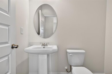 Bathroom with toilet and baseboards