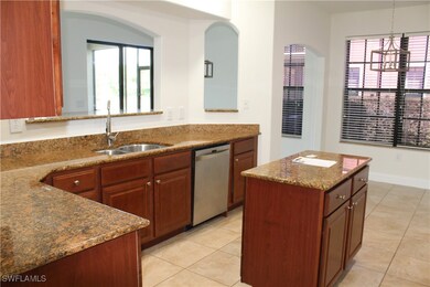 Kitchen with dishwasher, light tile patterned floo