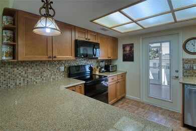 Kitchen showing back door to enclosed screen porch