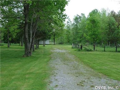 Land. Entrance to storage barn and fenced in garde