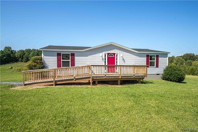 View of front of home with a front yard and wooden