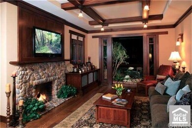 Family room with rock fireplace and glass doors to