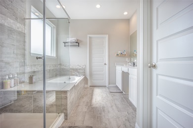 Primary bathroom with soaking tub and separate shower area.