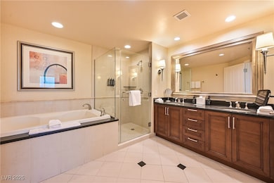 Full bathroom with double vanity, a garden tub, a