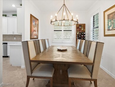 Dining area with crown molding, a chandelier, and light tile patterned floors