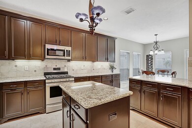 Premium updates in this beautiful island kitchen. Cabinets updated with paint, hardware & decorative wood trim to tops and bottoms.  Cabinets also have additional coat of protective clear guard to prevent chipping from wear and tear. Premium granite, island chandelier and stainless appliances were added enhancing the beauty of this space.