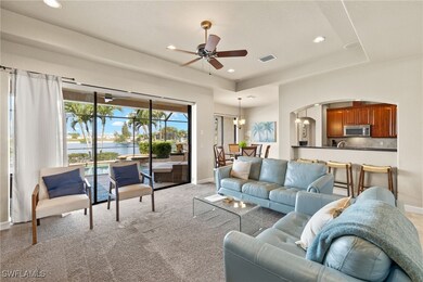 Living room with arched walkways, a water view, ce