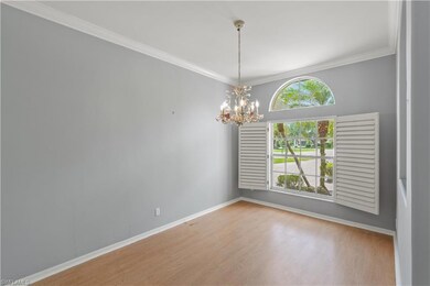 Spare room with baseboards, crown molding, wood fi