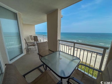 Balcony featuring a view of the beach and a water view
