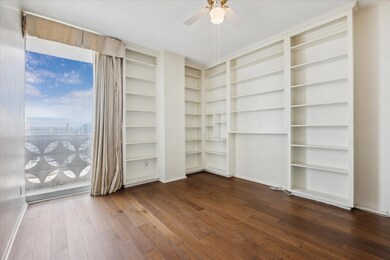 Spare room featuring dark wood-style floors, ceil