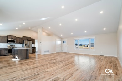 Unfurnished living room with light wood-style flooring, high vaulted ceiling, and recessed lighting