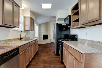 Kitchen has gas appliances and plenty of counter space along with many, many cabinets.