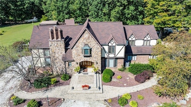Tudor house featuring stone siding and a chimney
