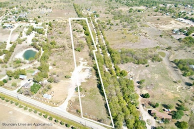 Aerial view of property and surrounding area featuring property boundaries highlighted and rural landscape