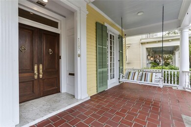 Wide, covered front porch and beautiful double doo