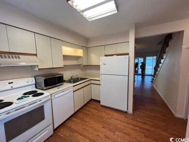 Kitchen with sink, white appliances, hardwood / wo
