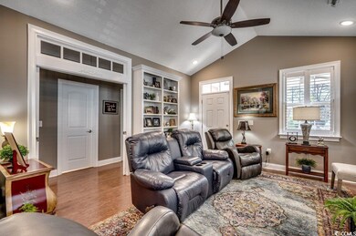 Living room featuring lofted ceiling, wood-type fl